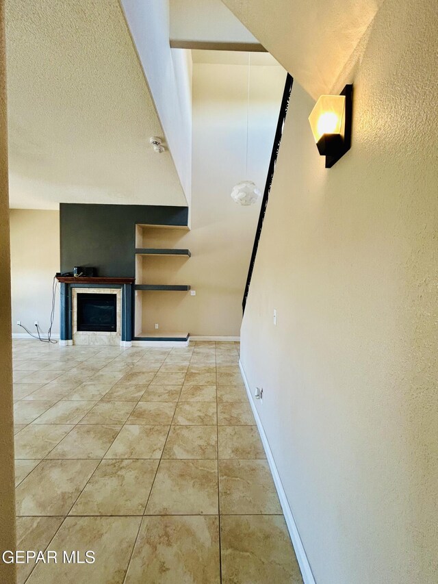 11609 Saint Thomas Way, El Paso, TX 79936 - corridor featuring baseboards, tile patterned flooring, and a textured ceiling