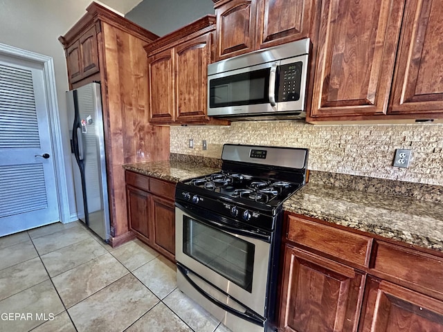 11609 Saint Thomas Way, El Paso, TX 79936 - kitchen with appliances with stainless steel finishes, tasteful backsplash, dark stone countertops, and light tile patterned floors