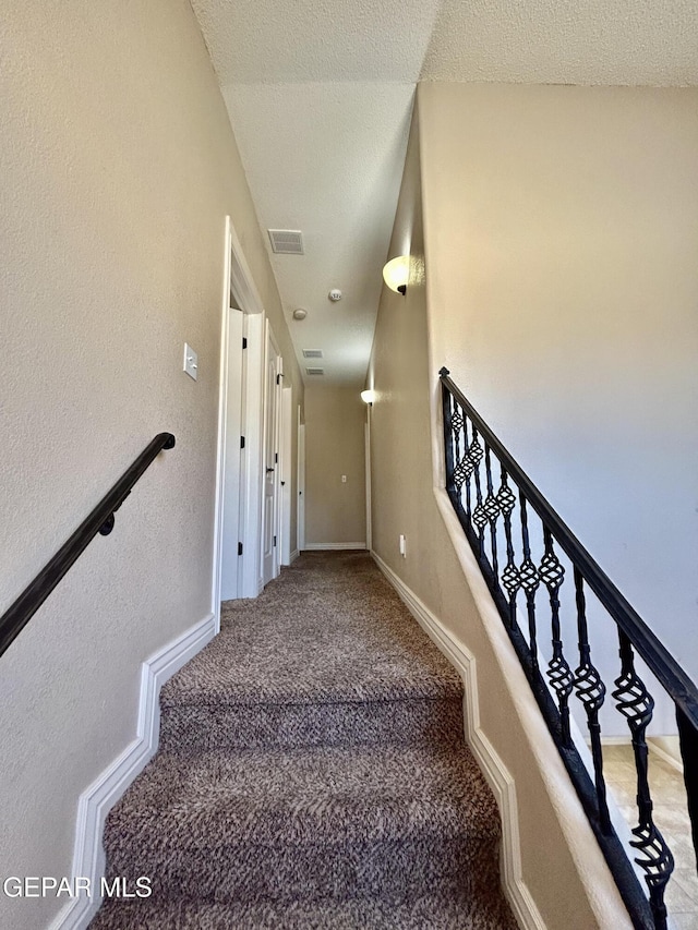 11609 Saint Thomas Way, El Paso, TX 79936 - stairway featuring carpet flooring, baseboards, and a textured ceiling