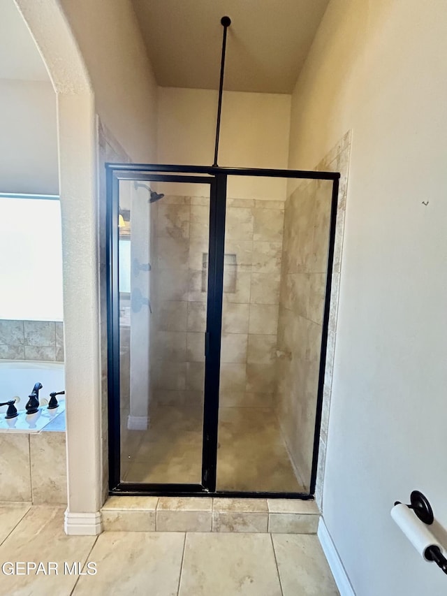 11609 Saint Thomas Way, El Paso, TX 79936 - bathroom with a shower stall, tile patterned flooring, and a bath