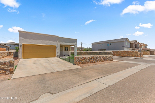 4817 Mark Avizo, El Paso, TX 79938 - view of front of property with stucco siding, a garage, concrete driveway, a residential view, and cooling unit