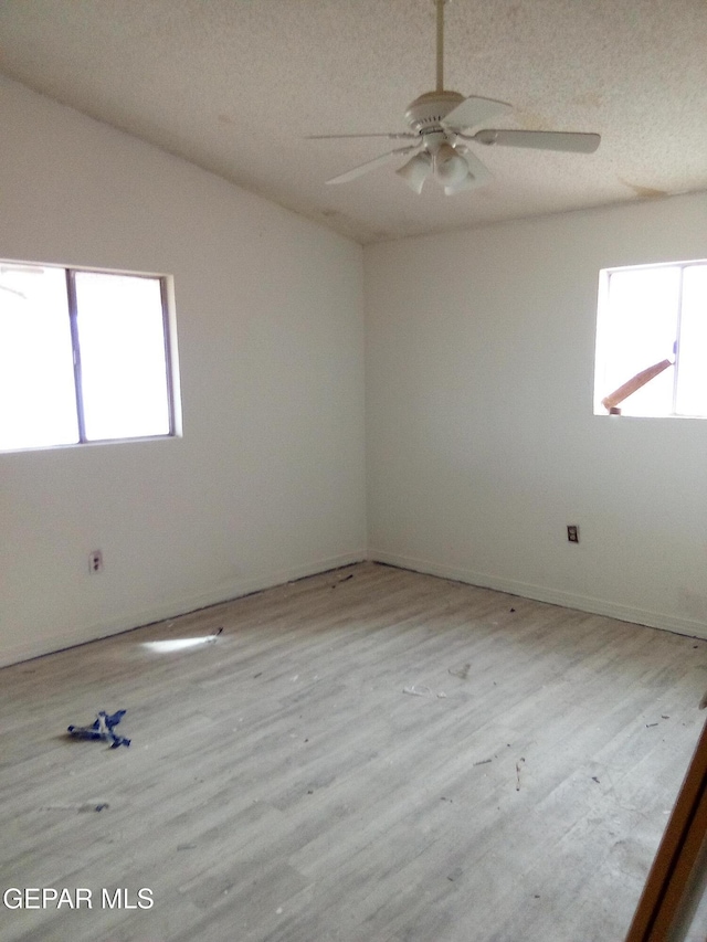 929 Coach Rd, Canutillo, TX 79835 - unfurnished room with healthy amount of natural light, a ceiling fan, wood finished floors, and a textured ceiling