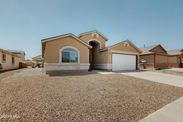 12009 Copper Point Pl, El Paso, TX 79934 - view of front of home with driveway, a garage, and stucco siding