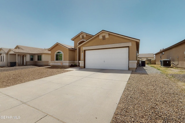 12009 Copper Point Pl, El Paso, TX 79934 - ranch-style house with stucco siding, central air condition unit, driveway, and an attached garage