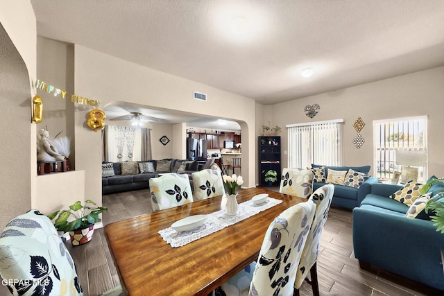 12009 Copper Point Pl, El Paso, TX 79934 - dining room with arched walkways, wood finished floors, and ceiling fan
