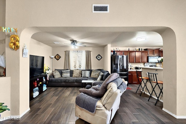 12009 Copper Point Pl, El Paso, TX 79934 - living room featuring arched walkways, dark wood-style flooring, ceiling fan, and baseboards