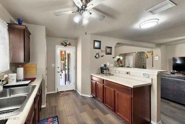 12009 Copper Point Pl, El Paso, TX 79934 - kitchen with arched walkways, open floor plan, a peninsula, a ceiling fan, and light countertops