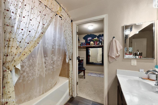 12009 Copper Point Pl, El Paso, TX 79934 - full bath featuring wood finished floors, vanity, and shower / bath combo with shower curtain