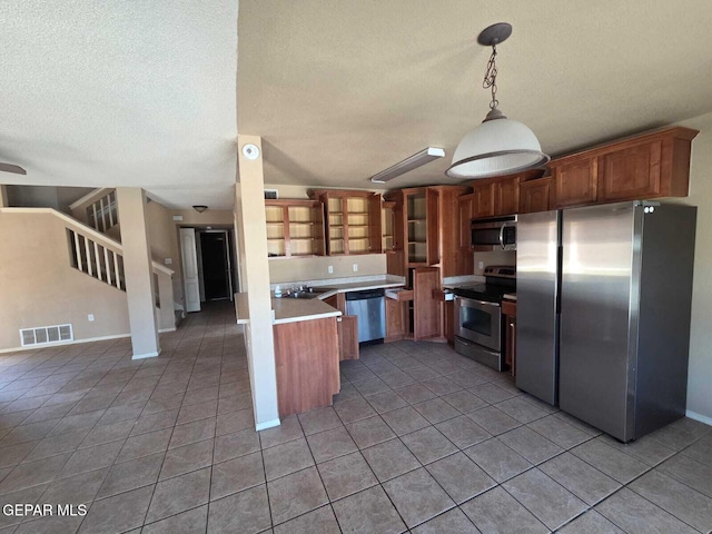 PPP10049 Paloma Dr, El Paso, TX 79924 - kitchen featuring stainless steel appliances, light tile patterned flooring, a textured ceiling, a sink, and light countertops