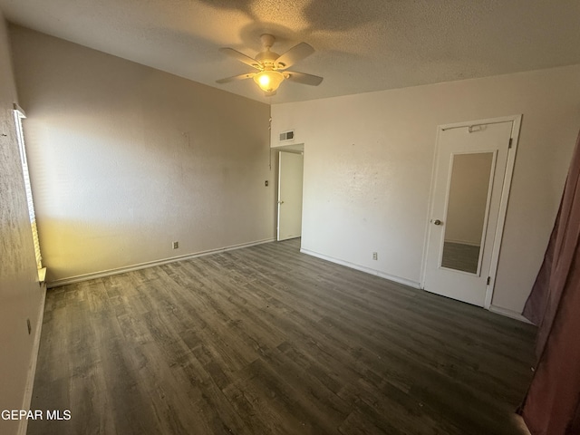 3216 Drumond Rd, El Paso, TX 79925 - unfurnished bedroom featuring dark wood-type flooring, a textured ceiling, baseboards, and ceiling fan