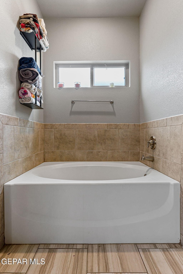13925 Lago Vista Ave, Horizon City, TX 79928 - full bath featuring plenty of natural light, a bath, and tile walls