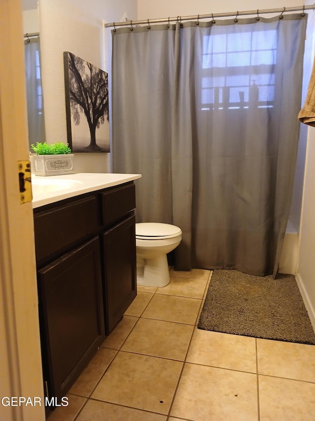 405 Santorini Ct, Socorro, TX 79927 - bathroom featuring tile patterned floors, vanity, toilet, and curtained shower