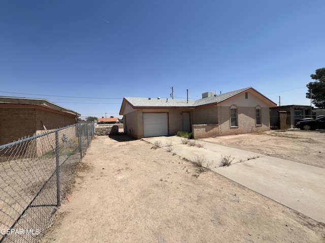 9129 Plymouth Dr, El Paso, TX 79907 - ranch-style house with driveway, an attached garage, and brick siding