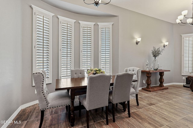12517 Winners Cir, El Paso, TX 79928 - dining area featuring a chandelier, baseboards, and wood finished floors