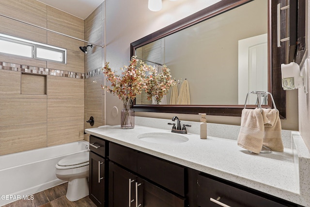 12517 Winners Cir, El Paso, TX 79928 - bathroom with toilet, vanity, tub / shower combination, and wood finished floors