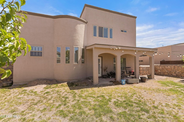 12517 Winners Cir, El Paso, TX 79928 - rear view of property featuring a patio, stucco siding, and a yard