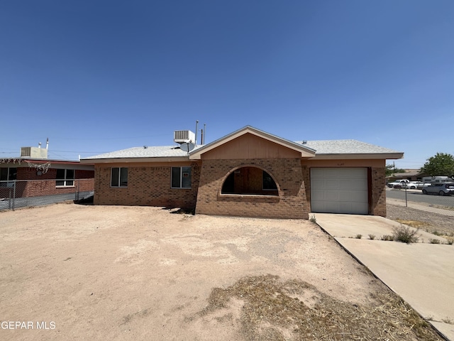 9145 Plymouth Dr, El Paso, TX 79907 - single story home with driveway, a garage, and brick siding