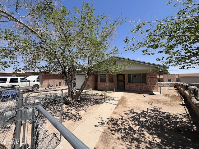 9217 Plymouth Dr, El Paso, TX 79907 - view of front facade with brick siding, a garage, and concrete driveway