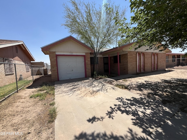 724 Haverhill Rd, El Paso, TX 79907 - view of front facade with an attached garage, brick siding, and concrete driveway