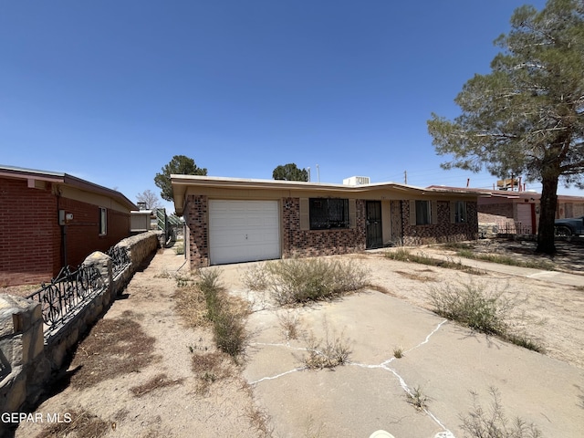 741 Haverhill Rd, El Paso, TX 79907 - view of front of property with driveway, a garage, and brick siding