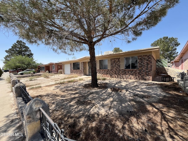 741 Haverhill Rd, El Paso, TX 79907 - single story home featuring a garage, brick siding, and driveway