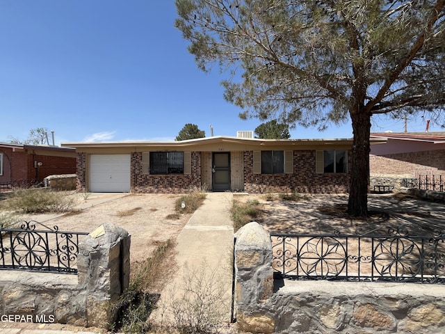 741 Haverhill Rd, El Paso, TX 79907 - view of front of home with brick siding, an attached garage, and dirt driveway