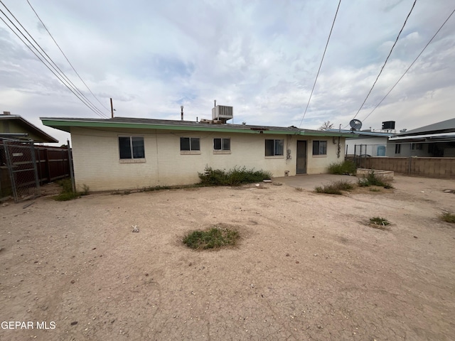 412 Indian Pl, El Paso, TX 79907 - rear view of house with central AC unit, brick siding, and a patio