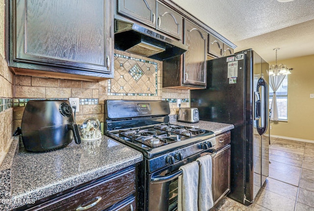 3844 Loma Cortez Dr, El Paso, TX 79938 - kitchen with range with gas cooktop, under cabinet range hood, tasteful backsplash, dark brown cabinetry, and a textured ceiling