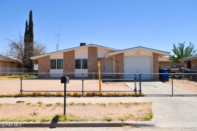 10824 Obsidian St, El Paso, TX 79924 - view of front of house with brick siding, driveway, and a garage