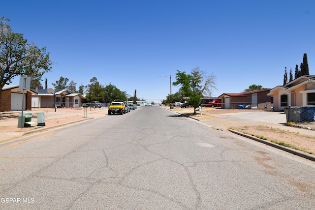 10824 Obsidian St, El Paso, TX 79924 - view of asphalt street featuring sidewalks, curbs, street lighting, and a residential view