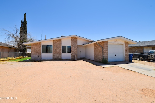 10824 Obsidian St, El Paso, TX 79924 - view of front facade featuring brick siding, a garage, and driveway