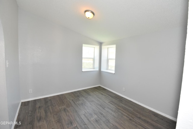 10824 Obsidian St, El Paso, TX 79924 - empty room with dark wood-style flooring, baseboards, and vaulted ceiling