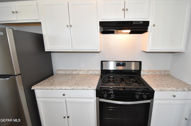 10824 Obsidian St, El Paso, TX 79924 - kitchen with under cabinet range hood, appliances with stainless steel finishes, and white cabinetry
