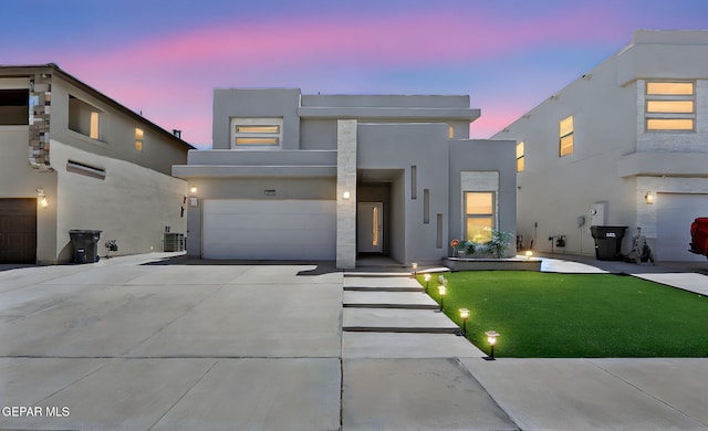 12816 Linstead Ave, El Paso, TX 79928 - contemporary house with stucco siding, an attached garage, concrete driveway, and a front yard