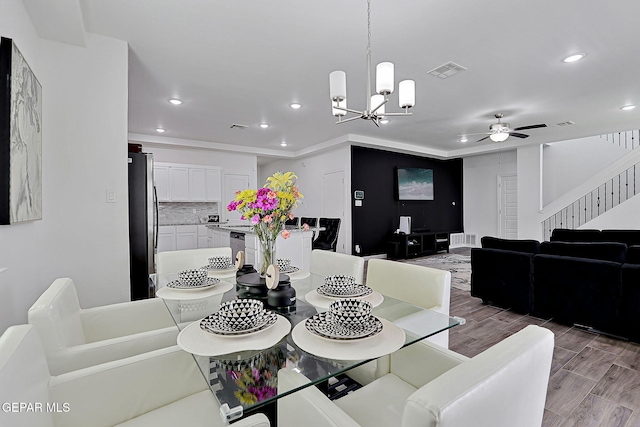 12816 Linstead Ave, El Paso, TX 79928 - dining room featuring recessed lighting, wood finished floors, stairway, a ceiling fan, and a chandelier