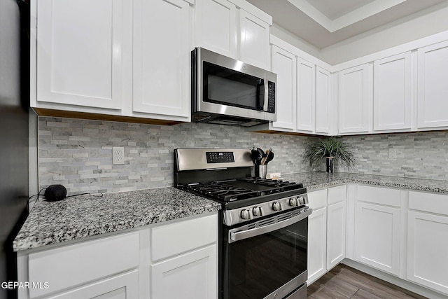 12816 Linstead Ave, El Paso, TX 79928 - kitchen with appliances with stainless steel finishes, white cabinets, and light stone counters