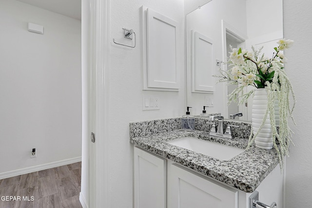 12816 Linstead Ave, El Paso, TX 79928 - bathroom featuring vanity, baseboards, and wood finished floors