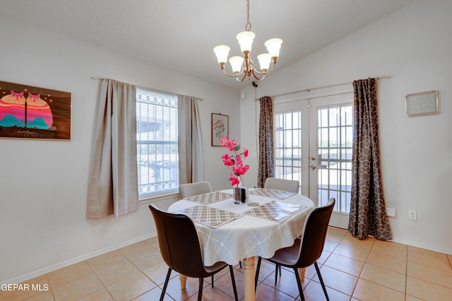 7930 Howard St, El Paso, TX 79904 - dining room with a chandelier, french doors, vaulted ceiling, light tile patterned floors, and baseboards