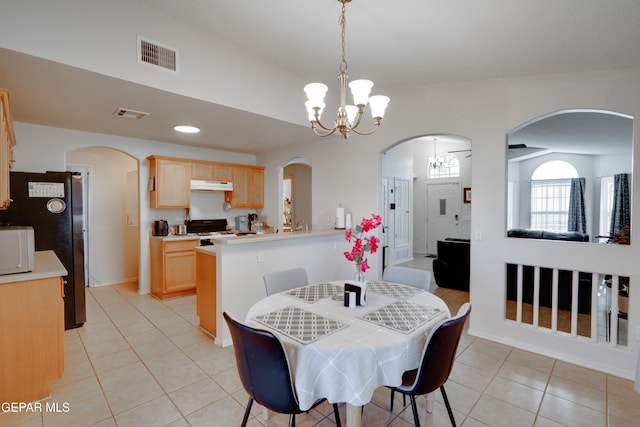 7930 Howard St, El Paso, TX 79904 - dining space featuring a chandelier, light tile patterned flooring, arched walkways, and baseboards