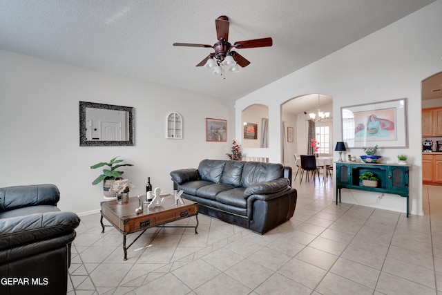 7930 Howard St, El Paso, TX 79904 - living area featuring arched walkways, a chandelier, ceiling fan, a textured ceiling, and light tile patterned flooring