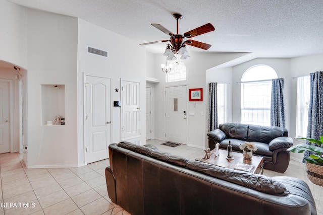 7930 Howard St, El Paso, TX 79904 - living area with high vaulted ceiling, ceiling fan, light tile patterned floors, a textured ceiling, and baseboards