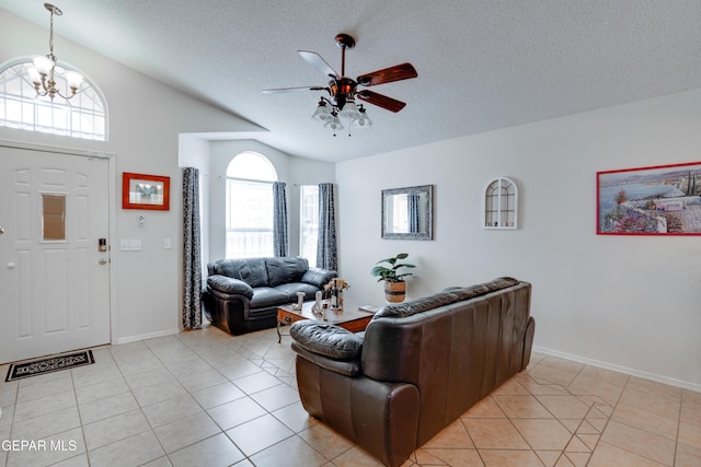 7930 Howard St, El Paso, TX 79904 - living room with ceiling fan, a textured ceiling, lofted ceiling, light tile patterned floors, and baseboards