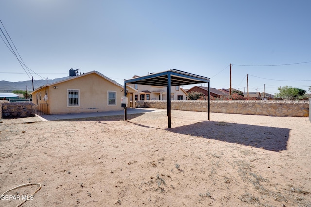 7930 Howard St, El Paso, TX 79904 - rear view of house featuring stucco siding and a patio area