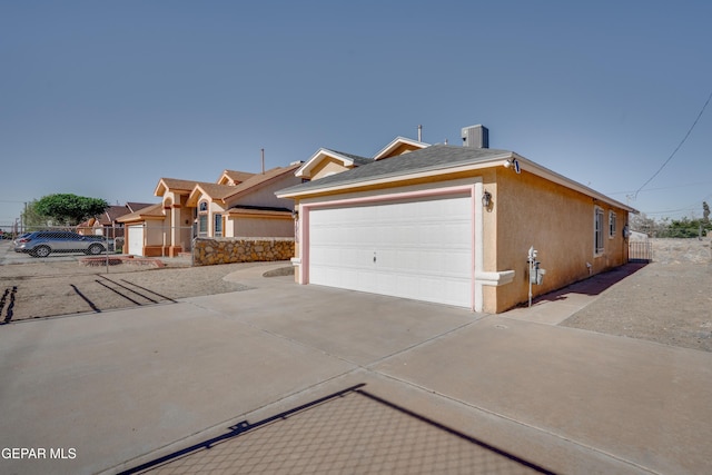 7930 Howard St, El Paso, TX 79904 - view of front facade with stucco siding, concrete driveway, and a garage