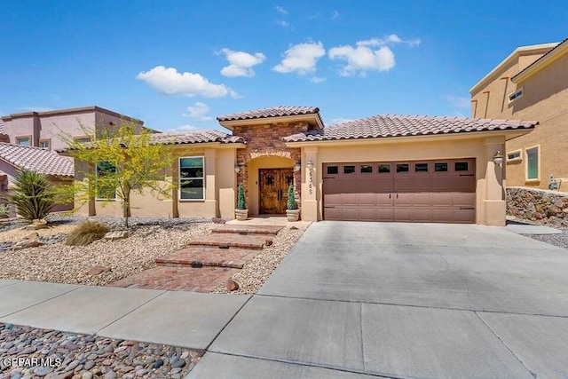 6365 Franklin Trail Dr, El Paso, TX 79912 - mediterranean / spanish-style house with a garage, concrete driveway, stucco siding, a tiled roof, and stone siding