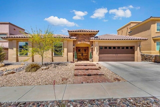 6365 Franklin Trail Dr, El Paso, TX 79912 - mediterranean / spanish-style home featuring a tiled roof, stucco siding, an attached garage, and concrete driveway