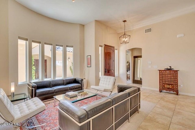 6365 Franklin Trail Dr, El Paso, TX 79912 - living area featuring arched walkways, a high ceiling, and light tile patterned floors