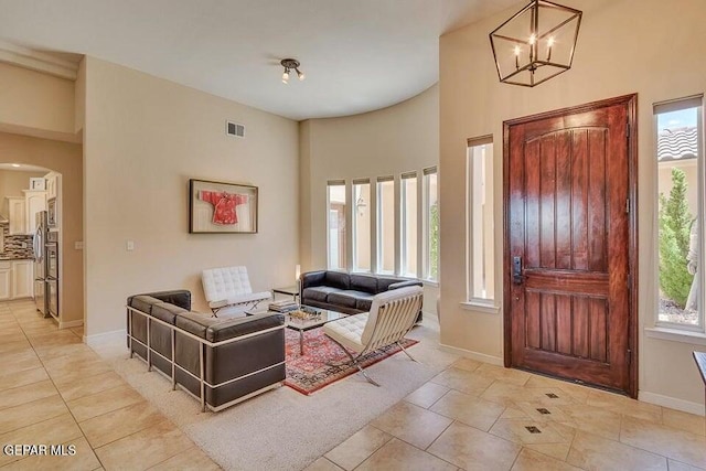 6365 Franklin Trail Dr, El Paso, TX 79912 - foyer entrance with arched walkways, a chandelier, light tile patterned floors, and a towering ceiling
