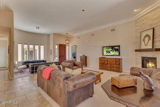 6365 Franklin Trail Dr, El Paso, TX 79912 - living area with a stone fireplace, arched walkways, light tile patterned flooring, and ornamental molding