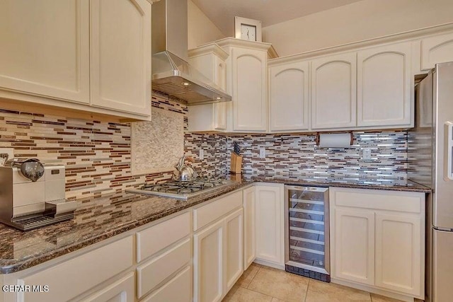 6365 Franklin Trail Dr, El Paso, TX 79912 - kitchen with beverage cooler, wall chimney range hood, stainless steel gas cooktop, decorative backsplash, and dark stone countertops